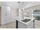 Bright and airy kitchen showcases custom white cabinets, stainless steel appliances, a quartz countertop, and new lighting fixtures at 2418 Whitehall Cir, Winter Park, FL 32792