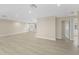 Spacious living room featuring light wood flooring, fresh paint, and plenty of natural light at 2418 Whitehall Cir, Winter Park, FL 32792