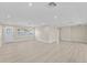 Large living room with recessed lighting and wood-look floors, featuring a front door with decorative glass and multiple windows at 2418 Whitehall Cir, Winter Park, FL 32792