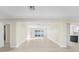Open living space with wood-look flooring connects seamlessly to the kitchen and backyard at 2418 Whitehall Cir, Winter Park, FL 32792