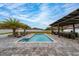 Backyard featuring a pool, palm tree, outdoor kitchen and lounge chairs at 2424 Varenna Loop, Kissimmee, FL 34741