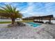 Backyard featuring a pool, palm tree, outdoor kitchen and lounge chairs at 2424 Varenna Loop, Kissimmee, FL 34741