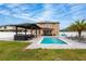 Expansive backyard with pool, covered patio, and well-manicured lawn at 2424 Varenna Loop, Kissimmee, FL 34741