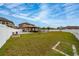 Spacious fenced backyard featuring a pool, patio, and manicured lawn at 2424 Varenna Loop, Kissimmee, FL 34741