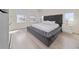 Bedroom featuring a plush grey bed, bench seating, and bright natural light at 2424 Varenna Loop, Kissimmee, FL 34741