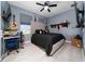 Comfortable bedroom with natural light, ceiling fan, and a dedicated workspace at 2424 Varenna Loop, Kissimmee, FL 34741