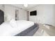 Bedroom featuring a plush grey bed with bench, television and white walls at 2424 Varenna Loop, Kissimmee, FL 34741