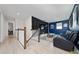 Upstairs media room with dark accent wall, comfortable seating, and mounted TV at 2424 Varenna Loop, Kissimmee, FL 34741