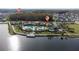 Beautiful community pool with palm trees, lounge chairs and lake view at 2424 Varenna Loop, Kissimmee, FL 34741