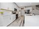 Modern white kitchen with stainless steel appliances, quartz countertops, and ample cabinet space at 2424 Varenna Loop, Kissimmee, FL 34741