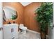 Stylish powder room with unique wood accent wall, modern vanity, and decorative mirror at 2424 Varenna Loop, Kissimmee, FL 34741