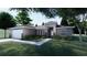A modern, single-story home with a combination of stone and gray siding and manicured landscaping at 30369 Apricot Ave, Eustis, FL 32736