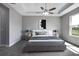 Comfortable main bedroom with a tray ceiling, a ceiling fan, and lots of natural light at 30369 Apricot Ave, Eustis, FL 32736