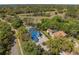 Aerial view of the property featuring the pool, tennis court, and lush landscaping, showcasing its prime location at 3326 Butler Bay N Dr, Windermere, FL 34786