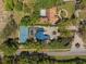 Aerial view of the property, highlighting the pool, tennis court, and landscaping. Adjacent to neighbors at 3326 Butler Bay N Dr, Windermere, FL 34786