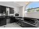 This spacious bathroom features sleek black marble counters and cabinetry, and a large soaking tub at 3326 Butler Bay N Dr, Windermere, FL 34786