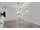 This bedroom has neutral carpeting, a ceiling fan, and a bright window at 3326 Butler Bay N Dr, Windermere, FL 34786