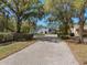 A lush driveway leads to this luxurious home with a blue tile roof at 3326 Butler Bay N Dr, Windermere, FL 34786