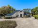 Elegant home with a blue roof and manicured landscaping, showcasing its curb appeal and inviting exterior at 3326 Butler Bay N Dr, Windermere, FL 34786