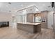 Bright kitchen with island, stone fireplace, and stainless steel appliances at 3326 Butler Bay N Dr, Windermere, FL 34786