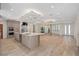 A modern, open-concept kitchen and living area features an island and wood-look tile floors at 3326 Butler Bay N Dr, Windermere, FL 34786