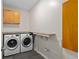 Well-equipped laundry room with modern washer and dryer, countertop space, and stylish tile flooring at 3326 Butler Bay N Dr, Windermere, FL 34786