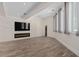 Spacious living room with stone accent wall, fireplace, large TV, and wood-look flooring for a cozy ambiance at 3326 Butler Bay N Dr, Windermere, FL 34786