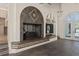 Living room with custom fireplace, tiled flooring, archways, and built-in shelving for added storage and style at 3326 Butler Bay N Dr, Windermere, FL 34786