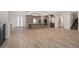Open-concept kitchen and living area features modern appliances, an island, and wood-look flooring throughout at 3326 Butler Bay N Dr, Windermere, FL 34786