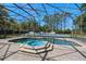 Screened-in pool area featuring a spa and a tennis court, perfect for outdoor enjoyment and recreation at 3326 Butler Bay N Dr, Windermere, FL 34786