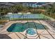 The screened-in pool and spa offer views of the tennis court at 3326 Butler Bay N Dr, Windermere, FL 34786