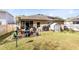 A spacious backyard with a wooden deck and well-maintained lawn, perfect for outdoor entertaining and relaxation at 34626 Salerno Cir, Sorrento, FL 32776
