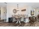 Cozy dining nook with a built-in bench, charming decor, and a convenient wine cooler at 34626 Salerno Cir, Sorrento, FL 32776