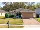 Charming single-story home with a brick driveway, well-maintained lawn and a two-car garage at 34626 Salerno Cir, Sorrento, FL 32776