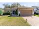 Charming single-Gathering home with well-manicured lawn, brick driveway, and attached two-car garage at 34626 Salerno Cir, Sorrento, FL 32776