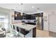 Sleek kitchen featuring an island with seating, stainless steel appliances, and ample counter space at 34626 Salerno Cir, Sorrento, FL 32776