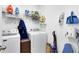 Functional laundry room with washer, dryer, storage shelves, and cleaning supplies at 34626 Salerno Cir, Sorrento, FL 32776