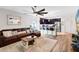 Cozy living room seamlessly connects to a modern kitchen with dark cabinets and stainless appliances at 34626 Salerno Cir, Sorrento, FL 32776