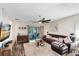 Spacious living room with sliding doors to the patio, a plush sofa, and stylish decor at 34626 Salerno Cir, Sorrento, FL 32776