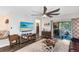 Comfortable living room featuring a large TV, plush seating, and easy access to the outdoor patio at 34626 Salerno Cir, Sorrento, FL 32776