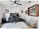 Home office featuring a wooden bookshelf, ceiling fan, and neutral walls at 34626 Salerno Cir, Sorrento, FL 32776