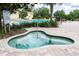 Relaxing spa beside a community pool with brick surround and lush landscaping creating a private oasis at 34626 Salerno Cir, Sorrento, FL 32776