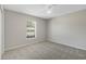 Bright bedroom featuring neutral walls, carpet flooring, and a window at 36 Se Almond Dr, Ocala, FL 34472