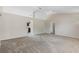 Open-concept living space with vaulted ceilings, ceiling fan, and seamless flow into the kitchen at 36 Se Almond Dr, Ocala, FL 34472