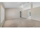 Large, inviting living room with neutral carpet, ceiling fan, and a spacious open layout at 36 Se Almond Dr, Ocala, FL 34472