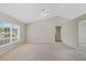 Bright living room with a ceiling fan and vaulted ceilings, showcasing ample space and natural light at 36 Se Almond Dr, Ocala, FL 34472