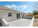 Outdoor patio with ample space for seating and entertaining, accessible through sliding glass doors at 36 Se Almond Dr, Ocala, FL 34472