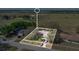 Aerial view of a home site with mature trees, a well-kept lawn, and a paved driveway at 37149 Sandy Ln, Grand Island, FL 32735