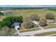 Aerial view of the home, neighborhood, and vast green fields, providing a sense of spaciousness at 37149 Sandy Ln, Grand Island, FL 32735