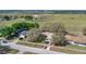 Aerial view of the property with surrounding fields and trees offering a serene, rural setting at 37149 Sandy Ln, Grand Island, FL 32735